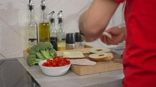 Preparing a Bagel Sandwich in a Kitchen