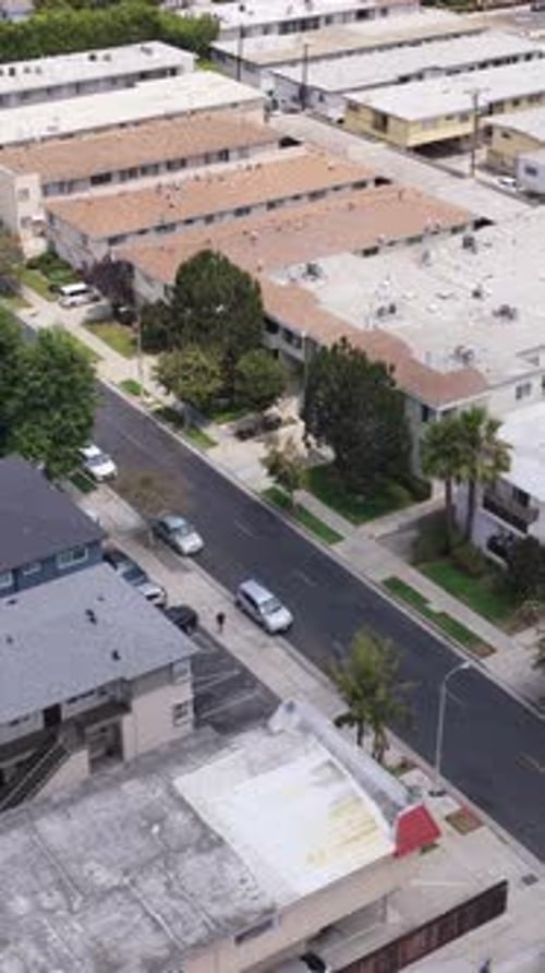 Urban Apartment Buildings and Quiet Street in Residential Los Angeles Neighborhood with Cars Parked