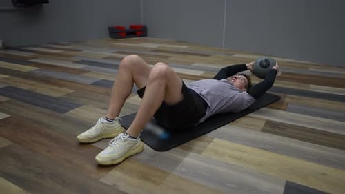 Fitness man trains in a modern gym