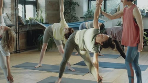 Yoga Instructor Teaching Female Students on Group Class