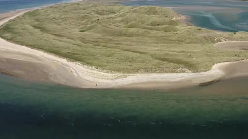 Aerial view: Turbulent outgoing tide at Tramore sand dunes, Ireland