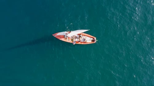 SUP surfers paddling along a Mediterranean coast