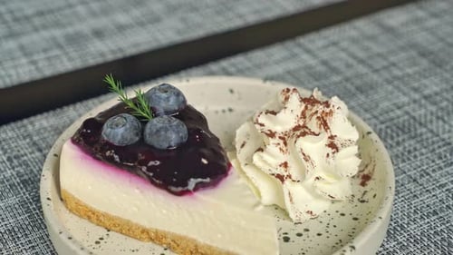 Blueberry Cheesecake Slice with Whipped Cream on Plate