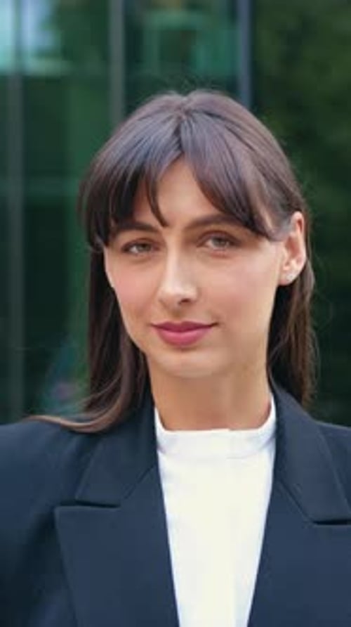 Smiling Woman Poses in Front of Office Building