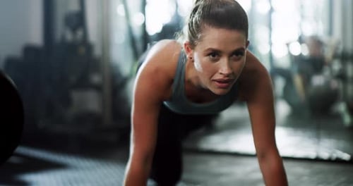 4k video footage of an attractive young sportswoman planking while working out in a gym