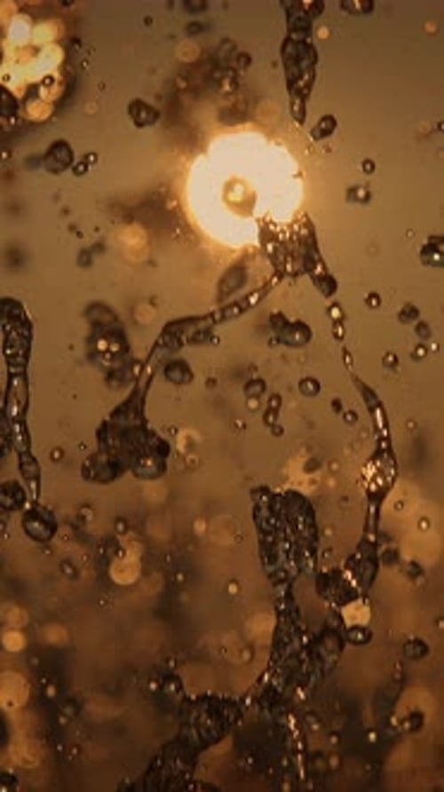 Abstract Golden Water Droplets in Vertical Video