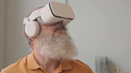 Senior Man Interacts with VR Headset Close Up
