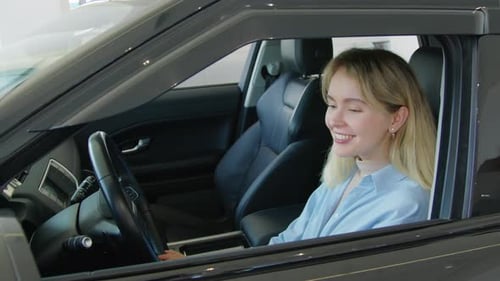 Joyful Young Woman Choosing New Car