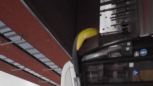Vertical shot of bus with passengers arriving at Leuven station, Belgium - Portrait mode