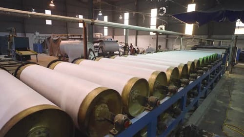 Drums roller and producing textile and fabric cloth in a manufacturing warehouse in Pakistan