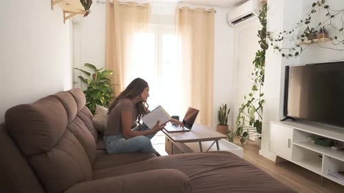 Woman Working on Laptop in Bright Living Room