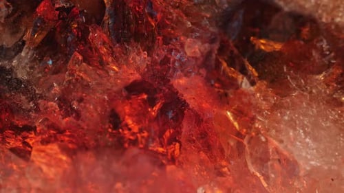 Intricate details of the surface of a citrine golden quartz studio-lit against a black background. S