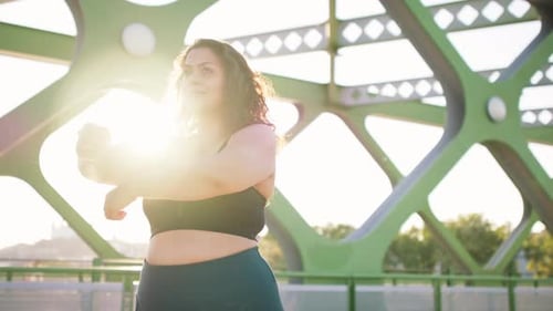 Close Up of Young Overweight Woman Exercising Outdoors in Bridge
