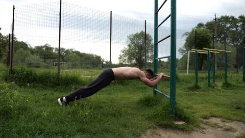 Man Works Out in Outdoor Fitness Park