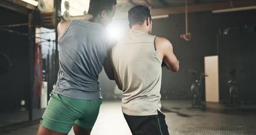 Men at gym, floor exercise with ball for strong body and muscle development for balance in power