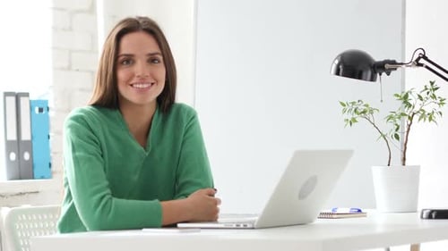 Creative Woman Looking at Camera in Office
