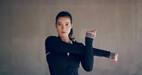 Woman Stretching Her Arm In Exercise Clothing