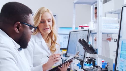 Scientists Collaborating on Medical Research in a Modern Lab