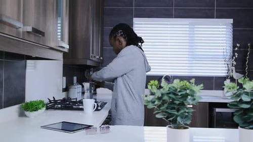Man Preparing Coffee in Modern Kitchen Interior