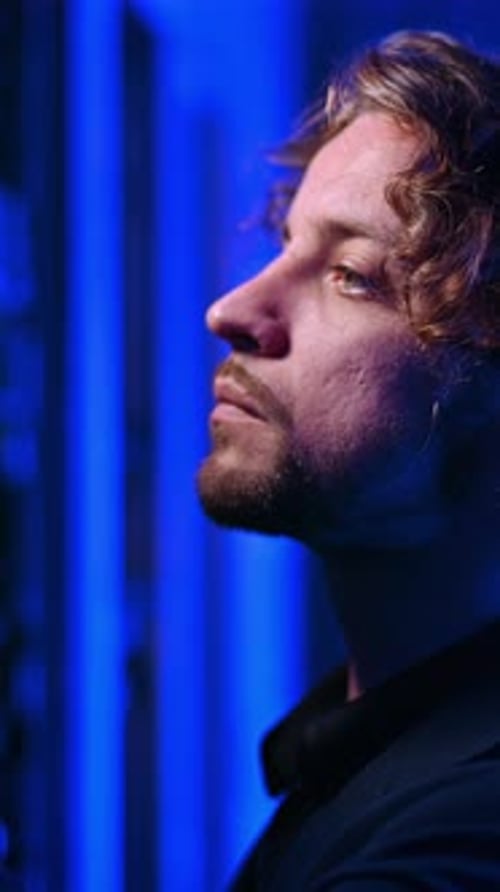 Man analysing servers in a data center. Vertical