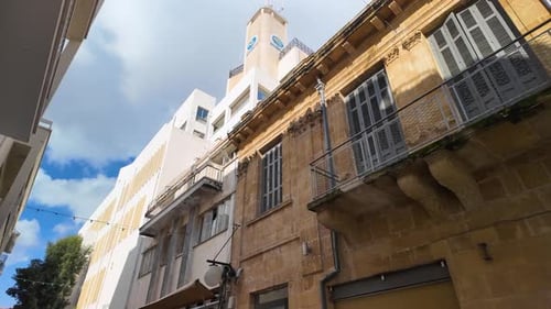 A street-level view of buildings in Nicosia, Cyprus, showcasing a mix of old and new architectural s