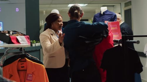 People Browse Clothes at a Retail Store