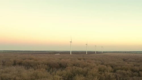 Aerial View of Powerful Wind Turbine Farm for Energy Production on Beautiful Cloudy Sky at Highland