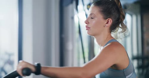 4k video footage of an attractive young sportswoman working out on an exercise bike in a gym