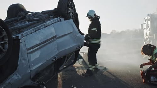 Emergency Responders Assist at Overturned Car Accident Scene
