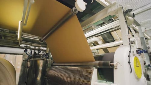 Machine Rolling Paperboard at a Manufacturing Factory