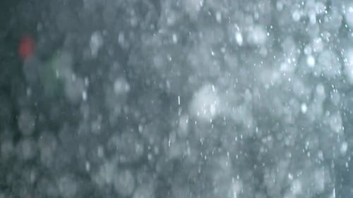 Collider Collection: Snowy dust bubble effect dropping over a black background