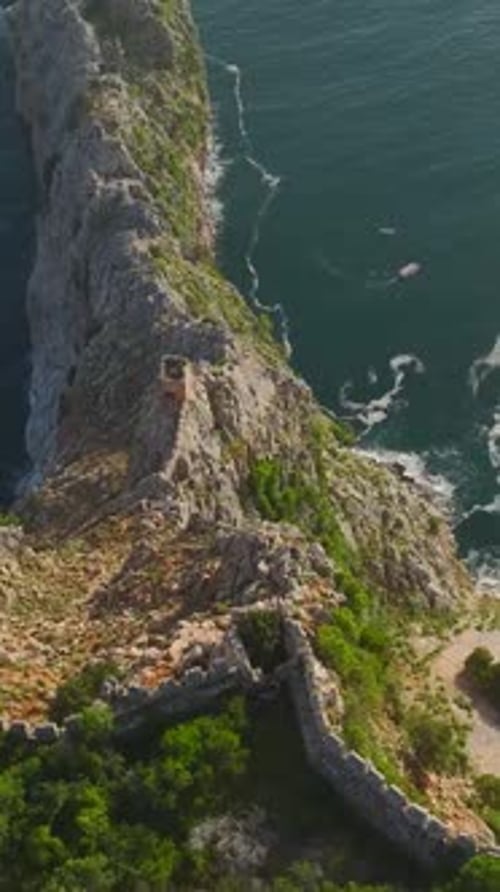 A Stunning Cliffside Location Highlights the Beauty of the Model and the Sea