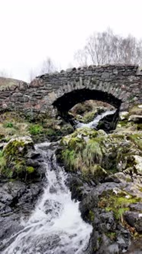 Ashness Bridge classic stone arch bridge Lake District. vertical video
