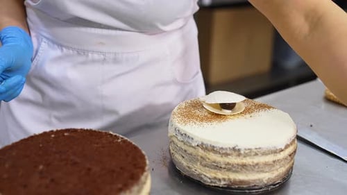 Cake Decorator Adding Finishing Touches to Layer Cake
