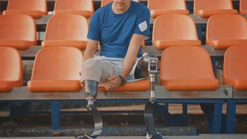 Athletic Disabled Fit Man with Prosthetic Running Blades is Preparing for a Training on an Outdoor