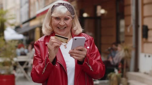 Senior Woman Using Credit Bank Card Smartphone While Transferring Money Purchases Online Shopping
