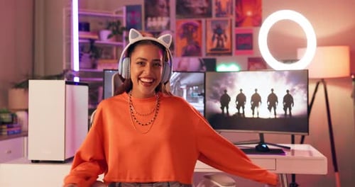 Smiling Woman with Headphones at Computer Desktop