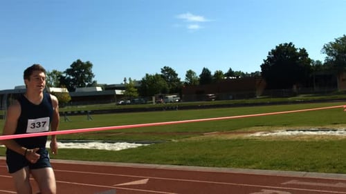 Track Runner Crosses Finish Line,