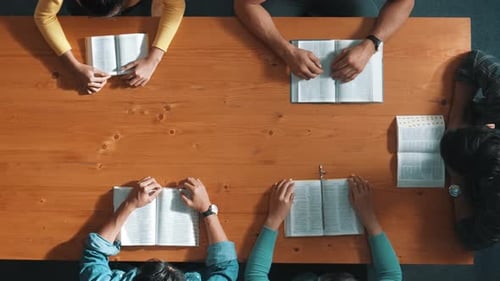 Top view of smart prayer hold each other support while prays to god. Symposium.