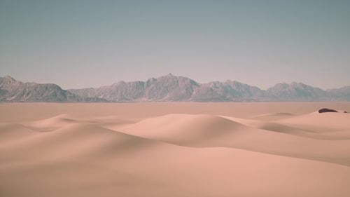 Arid Desert Landscape With Distant Mountains