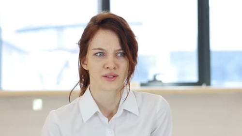 Woman Thinks Deeply in Office