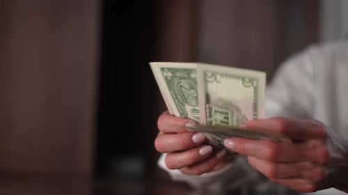 Older Woman Counting US Dollar Bills, Close Up