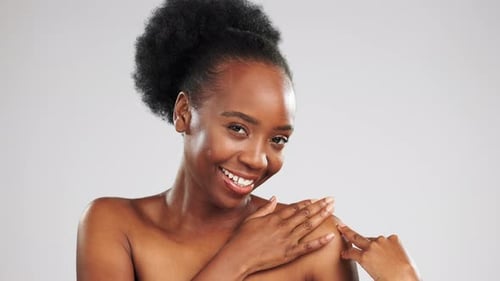 Black woman, face and beauty, laughter and skincare, happiness with glow on studio background