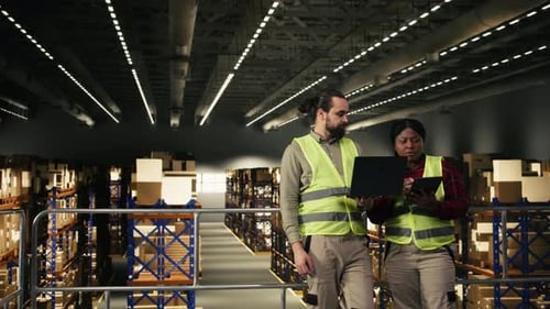 Warehouse Teamwork Showing Two Coworkers Managing Shipping Operations