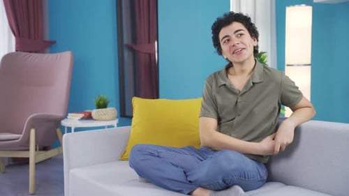 Young Adult Relaxing on Couch in Modern Home