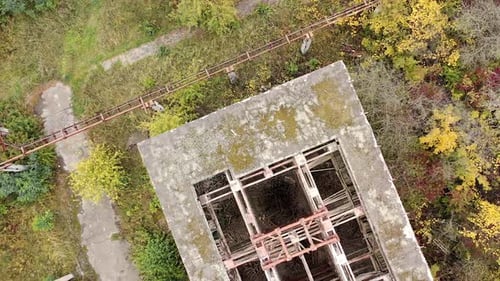 Destroyed building with holes in roof. Old abandoned building of industrial plant.