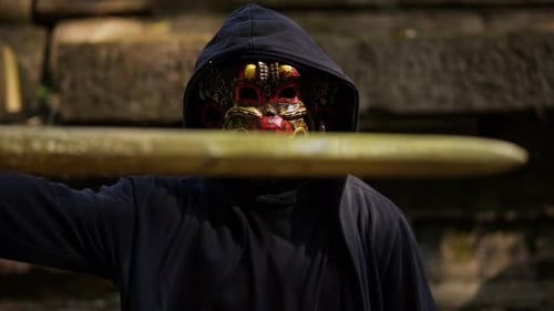 Mysterious Masked Figure with Staff