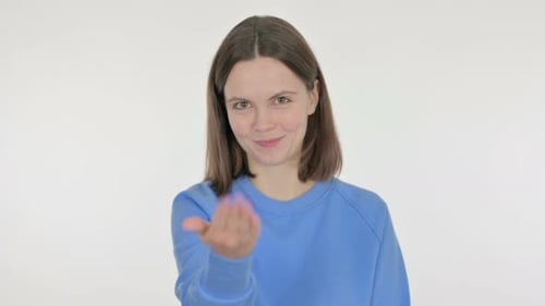 Young Woman Pointing at Camera Inviting on White Background