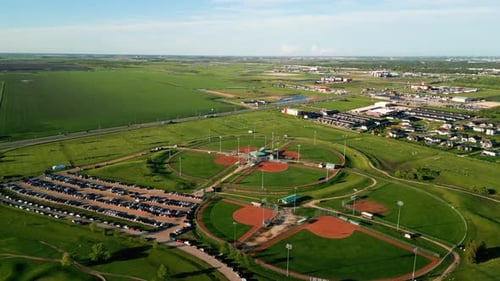 Drone Orbit on Sports Complex People Playing on an Outdoor Soccer Field Park in the Countryside of W