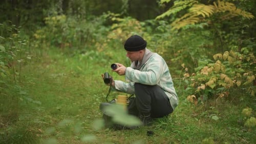 Hiker Enjoys Morning Coffee Hiker in Woods Peacefully Brewing Morning Coffee During Travel Serene